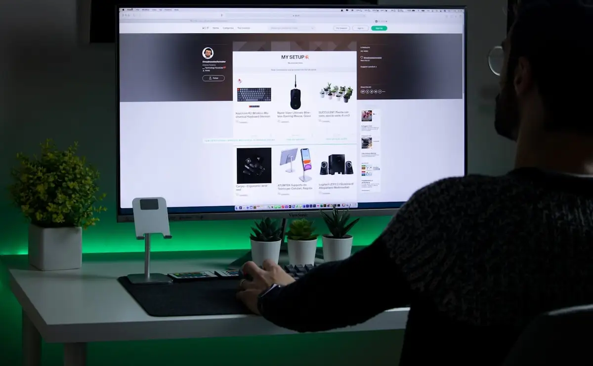 person in black sweater using computer